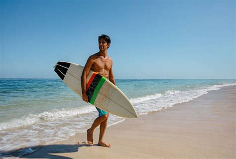 8100 Man Holding Surf Board At Beach Pictures Stock Photos Pictures