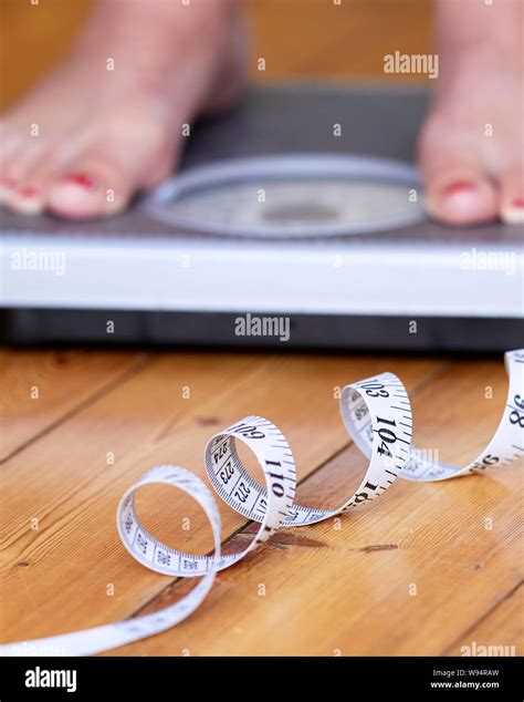 Person Stood On Scales Weighing Themselves Stock Photo Alamy