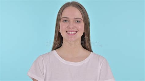 Portrait Of Smiling Beautiful Young Woman Blue Background Stock Photo