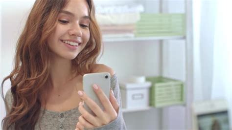 Smiling Woman Taking Mobile Selfie Photo On Phone At Bathroom Mirror