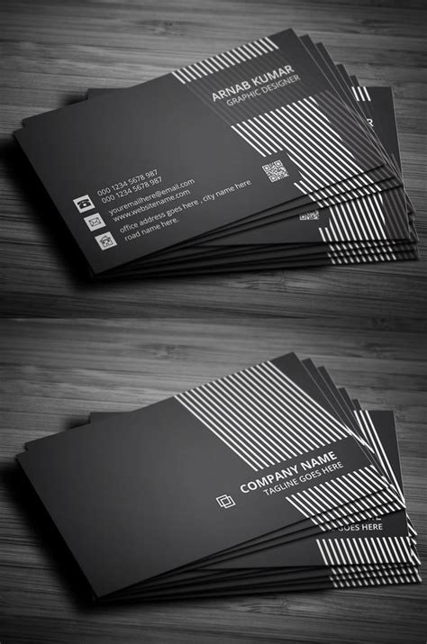 Two Black And White Business Cards On A Wooden Table