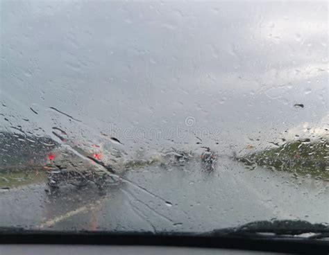 Frontal View Looking Through A Car Windshield During Rain Storm Stock