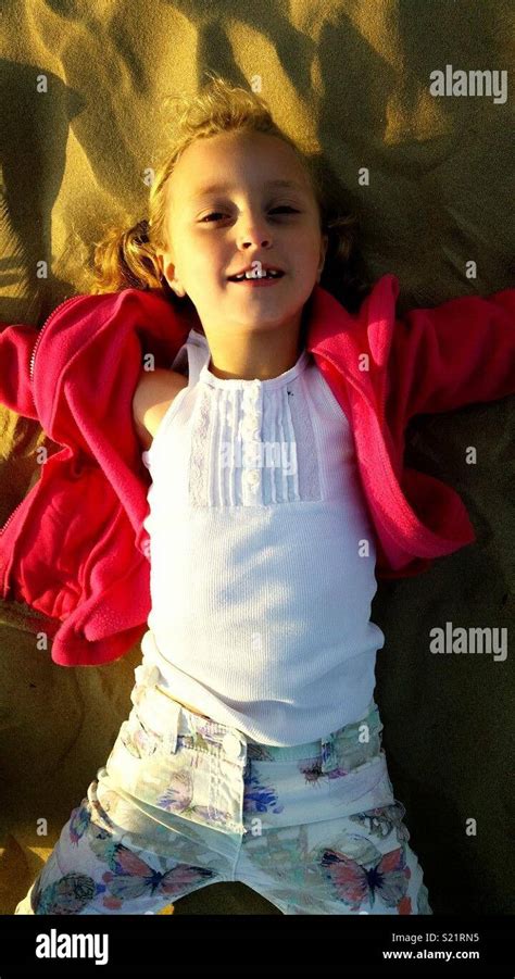 Daughter Making Sand Angels Stock Photo Alamy