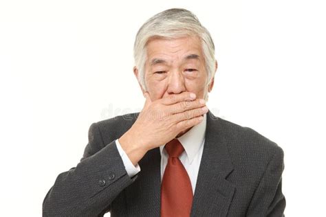 Senior Japanese Businessman Making The Speak No Evil Gesture Stock