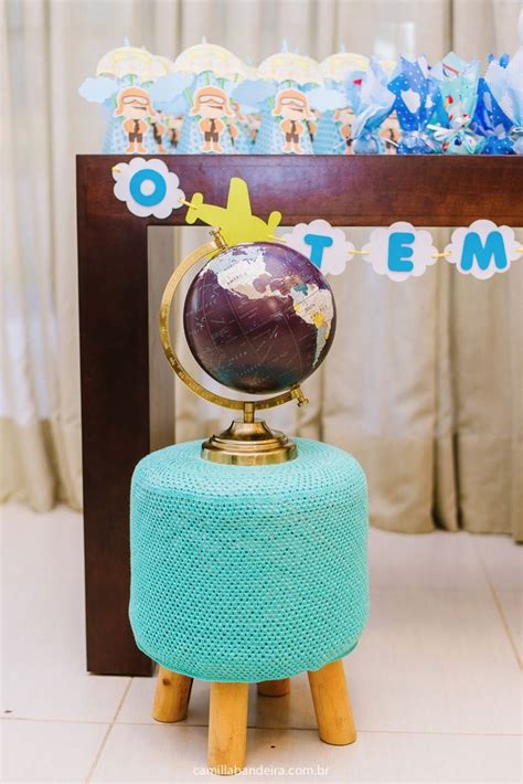 a small globe sitting on top of a blue stool in front of a wooden table