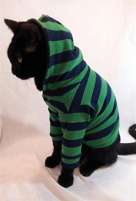While most people dress their cats up in costumes and outfits because they look cute, it could actually prove beneficial. Cat Hoodie Navy and Green Striped Cat Hoodie pet clothing cat