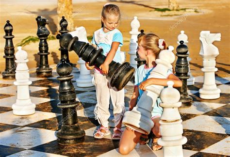 Children Play Chess Outdoor — Stock Photo © Poznyakov 27608289