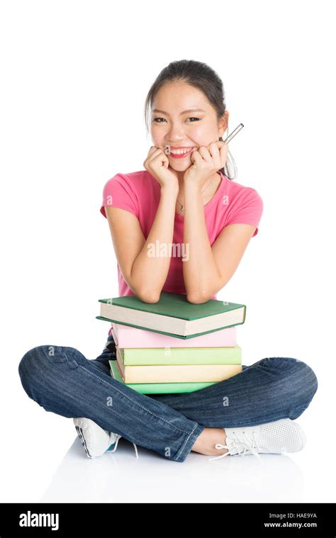 Full Body Young Asian Girl In Pink Shirt With Textbooks Seated On Floor Full Length Isolated