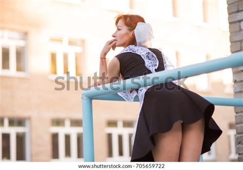 Beautiful Redhead Girl Bends Over Short Stock Photo 705659722