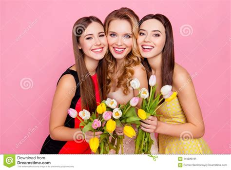 Pretty Nice Trio Of Girls In Dresses Having Colorful Tulips In Stock