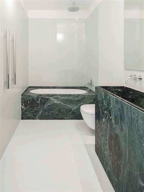 A Bathroom With Marble Counter Tops And White Walls Along With A