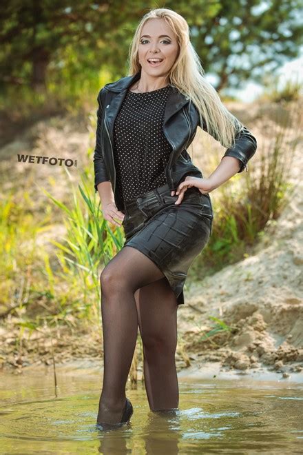 Total Black Wetlook By Blonde In Leather Jacket Skirt Stockings And