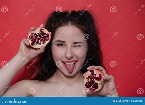 Portrait Brunette Woman Girl Female With Pomegranate Near Face On Red