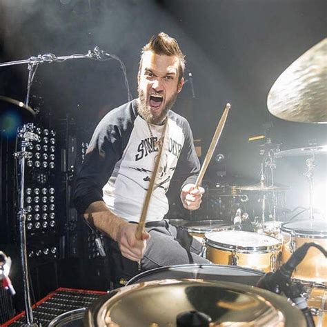 A Man Is Playing Drums On Stage