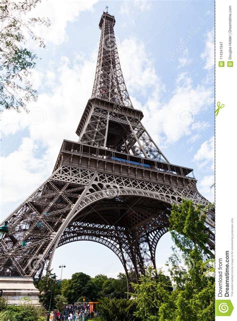 The Eiffel Tower With Tourists Lining Up For Tickets