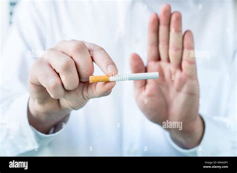 Doctor Telling To Quit Smoking Holding Cigarette Between Fingers And
