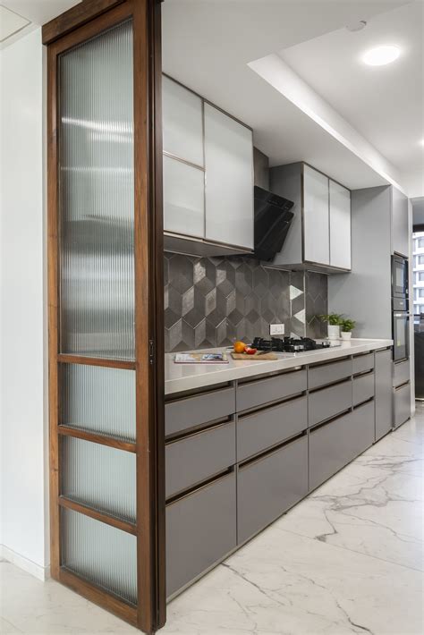 A White And Grey Kitchen With Hexagonal Metallic Tiles Used For