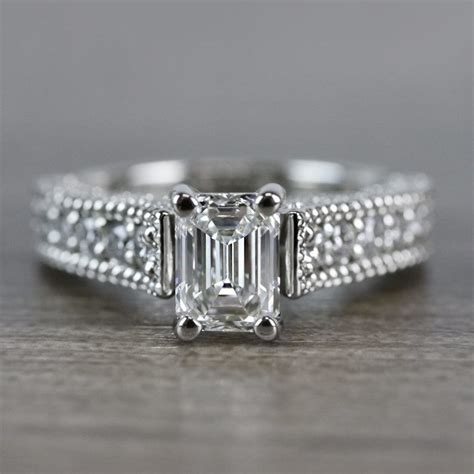 This engagement ring in 18 carat white gold with diamond 0.60 carat color k/l clarity si, igi certified, was made in 1950s. Mesmerizing Emerald Cut Diamond Vintage Engagement Ring