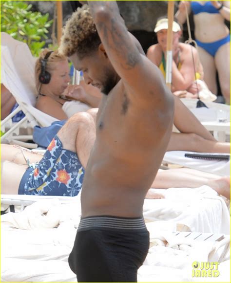 Usher Stays Clothed While Paddle Boarding Goes Shirtless On The Beach Photo