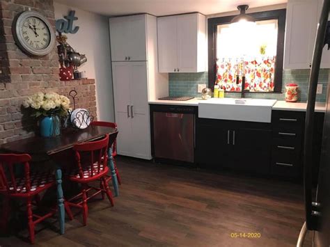 Touch device users, explore by touch or with swipe gestures. Pioneer woman kitchen. White upper, black lower cabinets ...