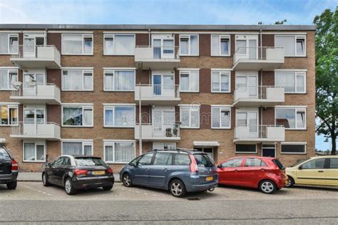 Cars Parked In Front Of An Apartment Building Editorial Stock Image