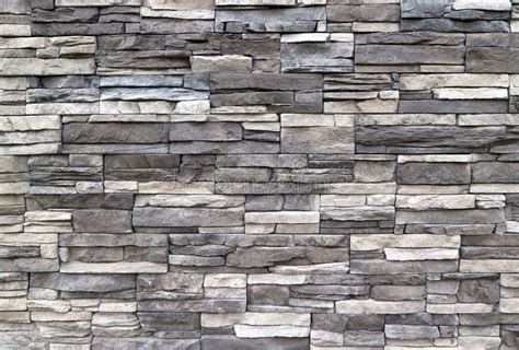 Stone Cladding Wall Made Of Striped Stacked Slabs Of Natural Rocks