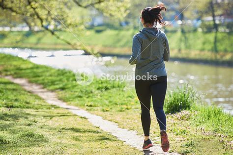 Young Woman Jogging In City Park At Early Morning Royalty Free Stock