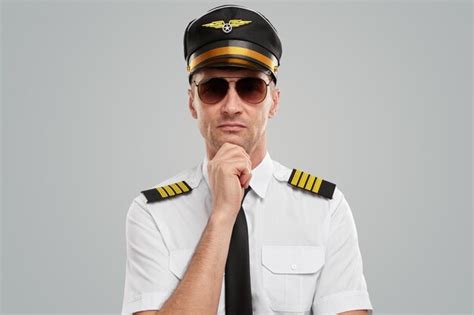 Premium Photo Confident Airline Pilot In Uniform Thinking