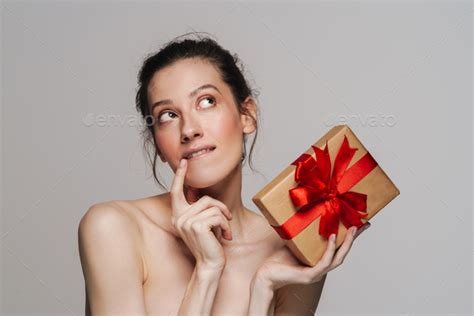 Pleased Half Naked Woman Thinking While Showing Gift Box Stock Photo By Vadymvdrobot