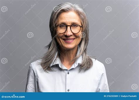 smiling gray haired female business woman wearing formal clothes standing with pleasure smile