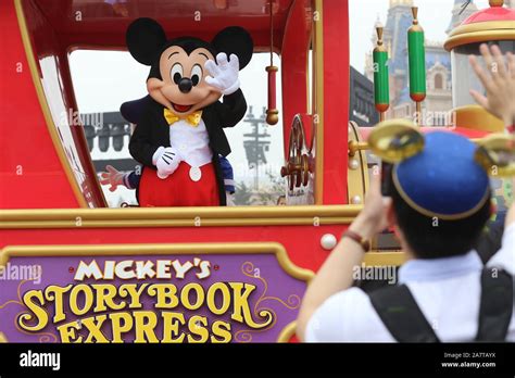 File An Entertainer Dressed In A Mickey Mouse Costume Interacts With