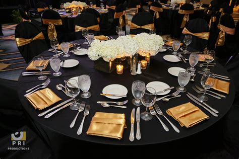Black And Gold Color Themed Table For A Dinner Reception Gold