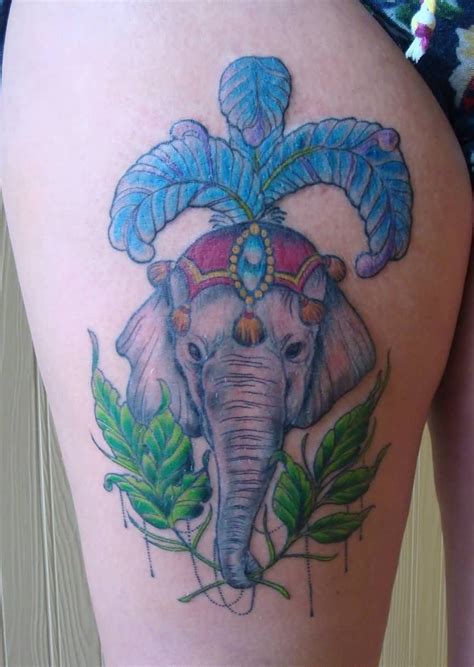 The tattoo shows an orange rose flower with a clock resting above the rose flower. Attractive Colorful Elephant Headdress Tattoo On Right ...