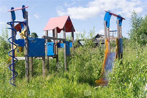 Old Neglected Playground Equipment Overgrown With Weeds Stock Image