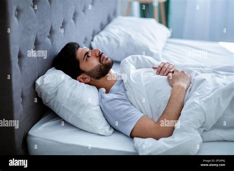 Insomnia Concept Depressed Arab Man Unable To Sleep Lying In Bed And