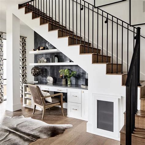 A Living Room Filled With Furniture Next To A Stair Case