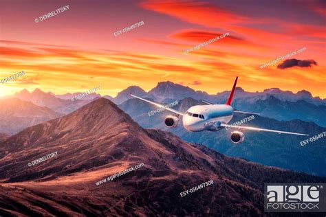 Airplane Is Flying Over Mountains At Colorful Sunset In Summer Stock