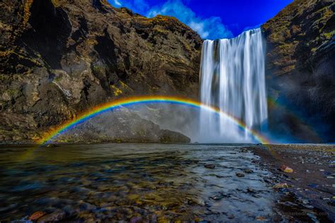 a beautiful double rainbow forms over the skógafoss waterfalls in iceland sigmà sreedharan