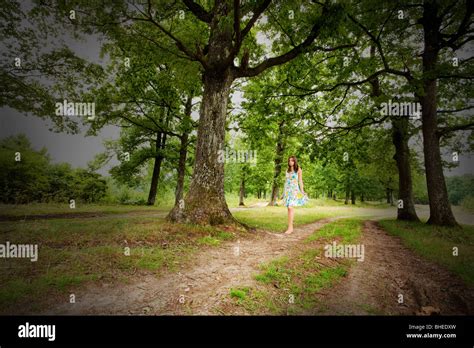 Portrait Of A Barefoot Woman Walking Alone In The Forest Stock Photo