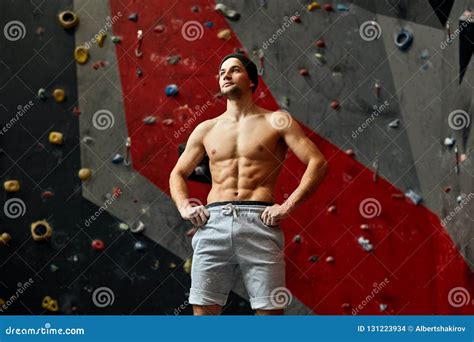 Portrait Of Cheerful Rock Climber In Indoor Climbing Gym Stock Photo
