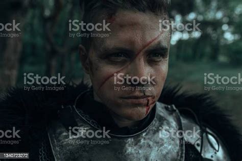 Portrait Of Medieval Knight In Armour With Face Scar Stock Photo