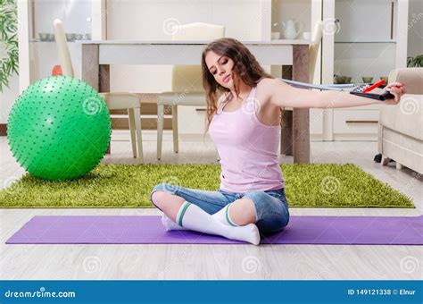 The Young Beautiful Woman Doing Exercises At Home Stock Photo Image
