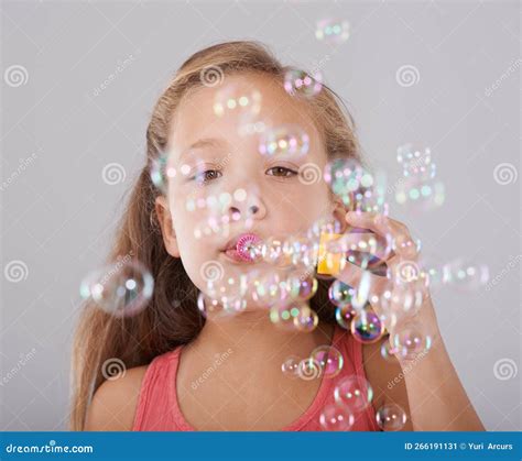 Fun With Bubbles Portrait Of A Cute Little Girl Blowing Bubbles Stock