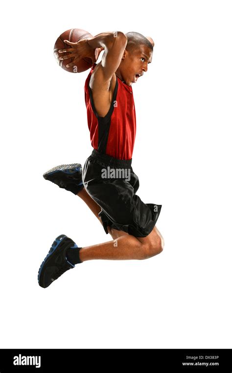 African American Basketball Player Dunking Ball Isolated Over White