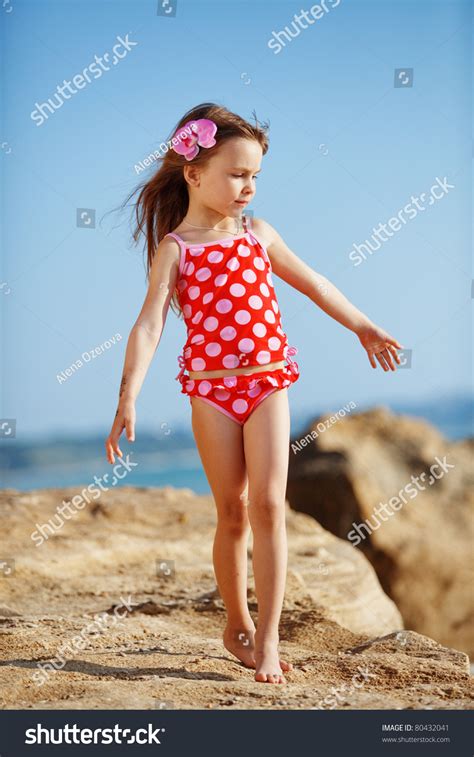 Cute Child Wearing Swimsuit Walking At Beach In Summer Stock Photo