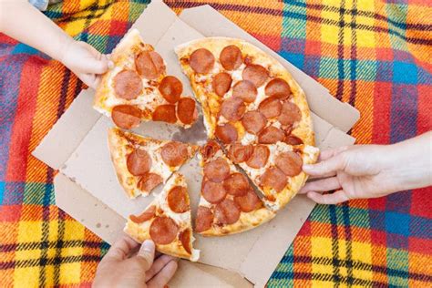 Hands Take Slices Of Pepperoni Pizza Food Delivery Picnic Stock Image