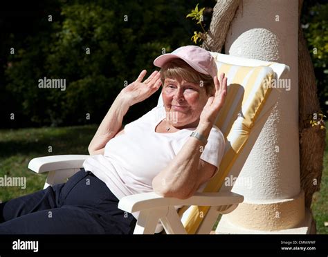 Elderly Woman Sunbathing Stock Photo Alamy