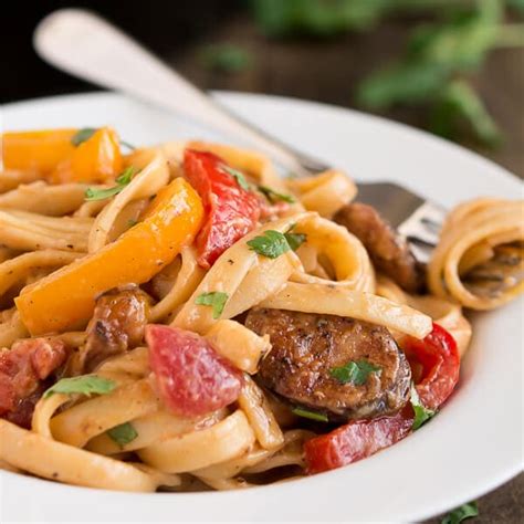 Andouille, a requirement for many cajun dishes, is a smoked sausage made with garlic, peppers, onions and seasonings. Creamy Cajun Pasta with Smoked Sausage - Oh Sweet Basil