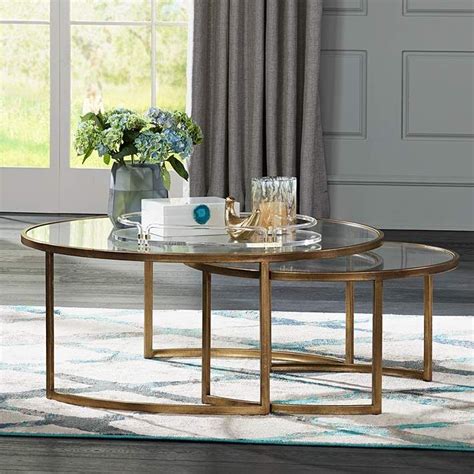 The coffee table is the perfect size for your beverages, books, or even when you want to put your feet up at the end of a long day. Rhea 42" Wide Gold Leaf and Glass Nesting Tables 2-Piece ...
