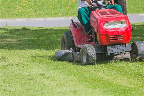 The Gardener Is Using A Lawn Mower Stock Photo Image Of Machine